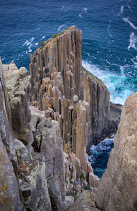 High angle view of rocks on sea shore