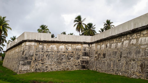 View of old building against cloudy sky