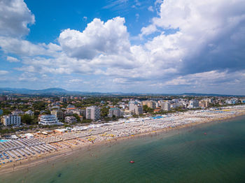 High angle view of buildings by sea against sky