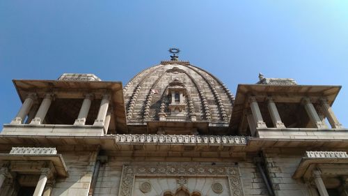 Low angle view of built structure against clear blue sky