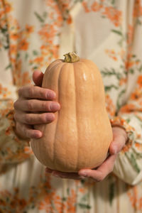 Close-up of hand holding pumpkin