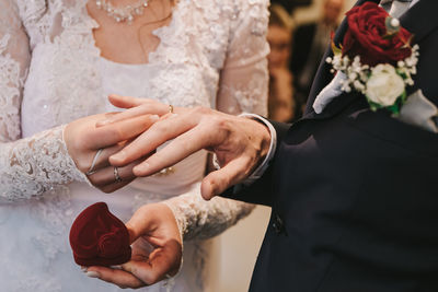 Midsection of couple holding hands