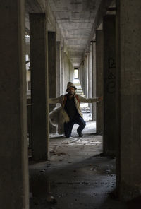 Full length of woman in corridor of building