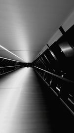 Illuminated footbridge against sky