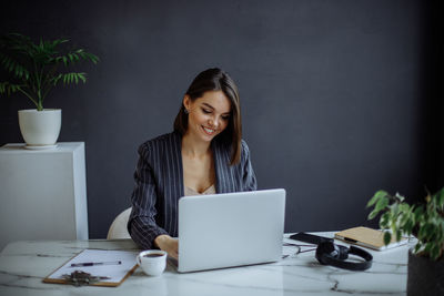 Young woman using laptop at table