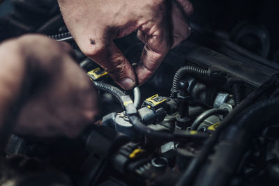 Cropped image of mechanic repairing car