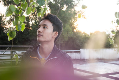 Portrait of young man looking at swimming pool