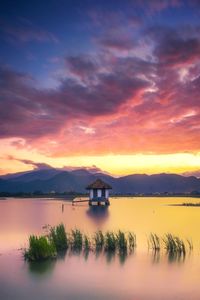 Scenic view of lake against sky during sunset