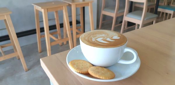 Coffee and biscuits on table