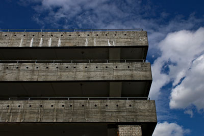 Low angle view of building against cloudy sky