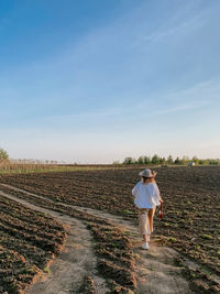 Full length of woman walking on field