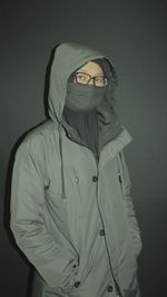 Portrait of man standing against white background