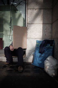 Full length of man sitting in corridor