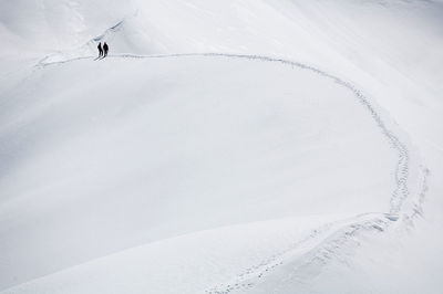 Scenic view of people on snow covered aiguille de rochefort