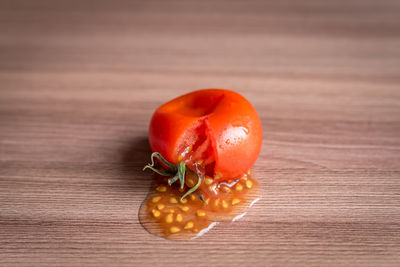 Close-up of  squeezed tomato on table