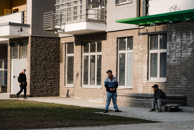 People standing by buildings in city