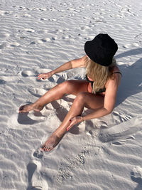 High angle view of woman lying on sand