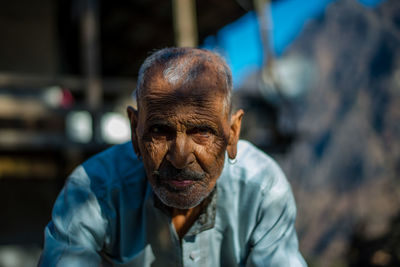 Close-up portrait of man wearing mask outdoors