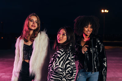 Portrait of smiling young women standing in nightclub