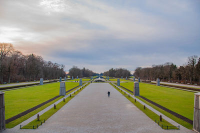 Footpath in park against sky