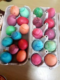 High angle view of colorful easter eggs in carton