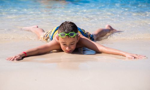 Full length of boy playing in swimming pool