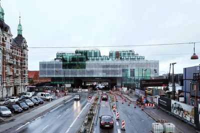 Traffic on road in city against sky