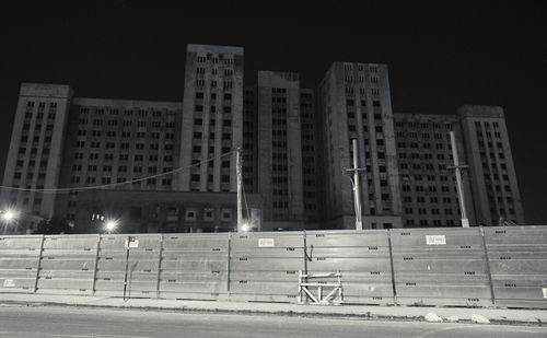 Low angle view of illuminated buildings against sky at night