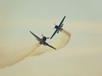 Low angle view of airplane flying against sky