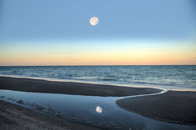 Scenic view of sea against sky at sunset