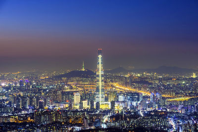 High angle view of city lit up at night