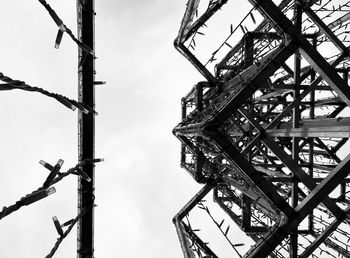 Low angle view of crane against sky