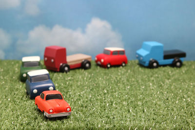 Close-up of toy cars on grass