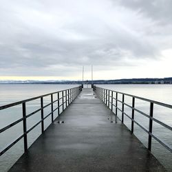 Pier over sea against sky