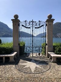 Metal railing on mountain against sky