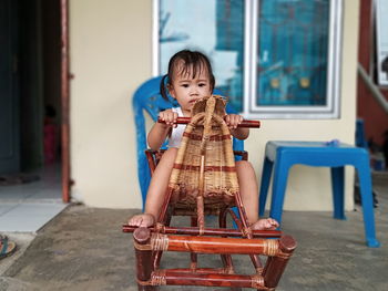 Cute boy holding camera at home