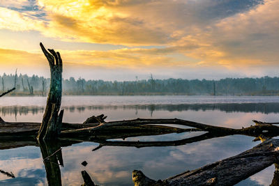 Scenic view of lake against sky during sunset