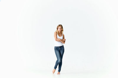 Portrait of smiling young woman against white background