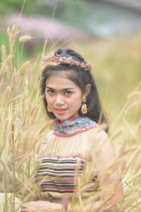 Portrait of a smiling young woman on field