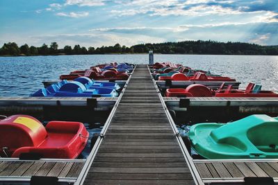 View of boats moored in lake against sky