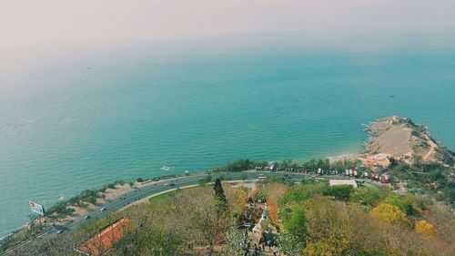 High angle view of sea and cityscape against sky