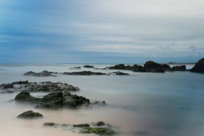 Scenic view of sea against cloudy sky