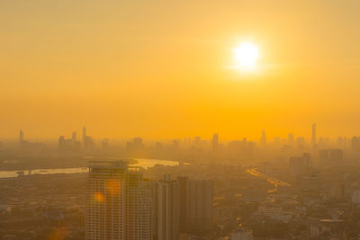 View of buildings in city during sunset