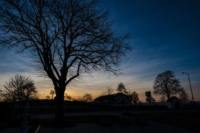 Silhouette trees against sky during sunset