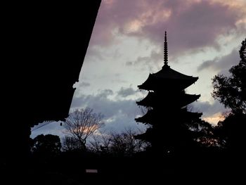 Low angle view of silhouette tree against cloudy sky