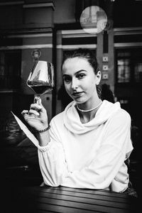 Portrait of woman holding ice cream in restaurant