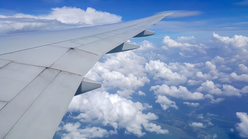 Aerial view of airplane flying in sky