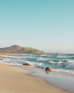 Scenic view of beach against clear sky