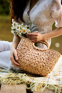 Midsection of woman holding blanket