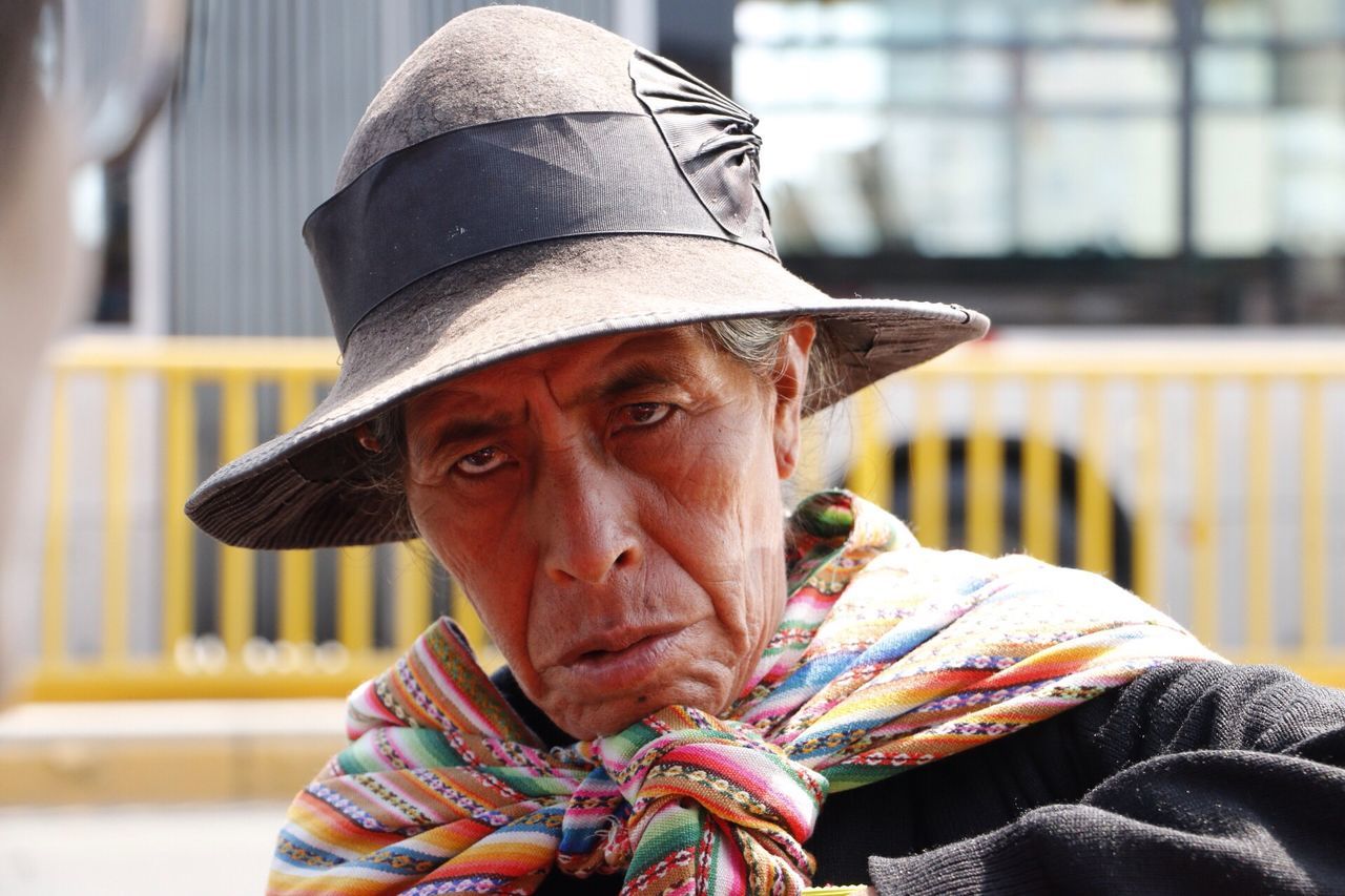 one person, portrait, hat, real people, clothing, senior adult, headshot, adult, lifestyles, focus on foreground, males, looking at camera, senior men, day, wrinkled, sitting, men, close-up, mature men, contemplation, outdoors